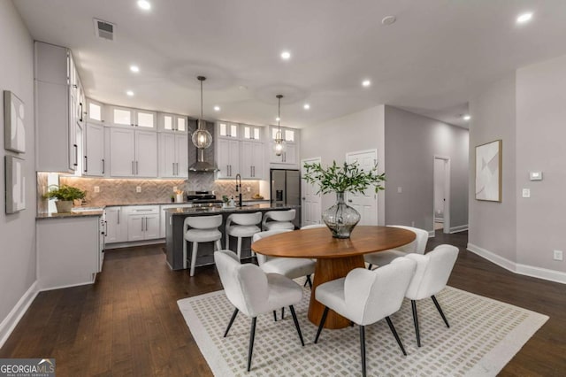 dining area with dark wood-type flooring and sink