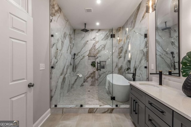 bathroom with vanity and independent shower and bath