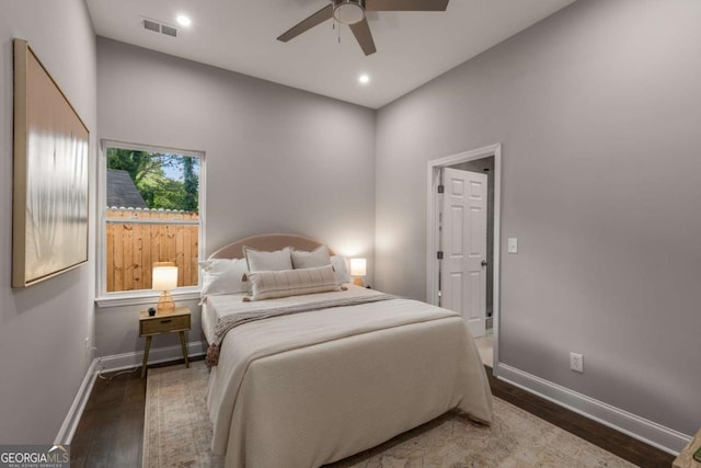 bedroom with ceiling fan and dark hardwood / wood-style flooring