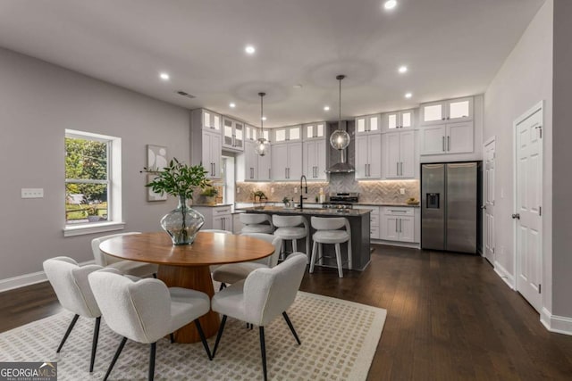 dining space featuring sink and dark hardwood / wood-style flooring