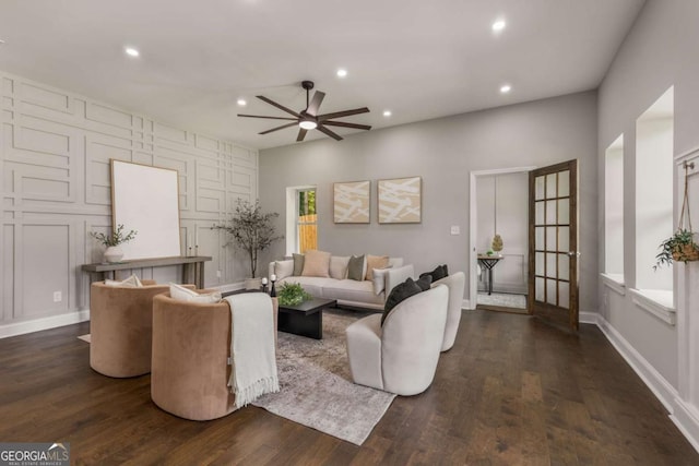 living room featuring dark hardwood / wood-style flooring and ceiling fan