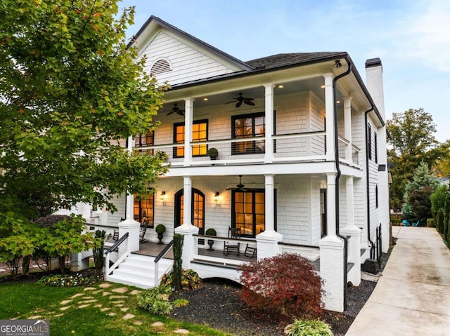 view of front of property featuring a porch, a balcony, and ceiling fan