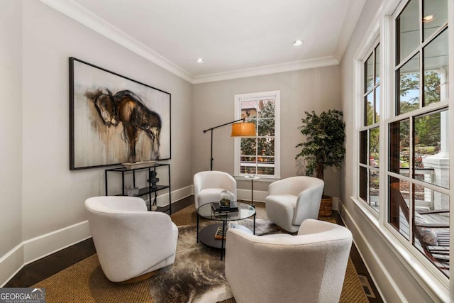 living area featuring hardwood / wood-style flooring and crown molding