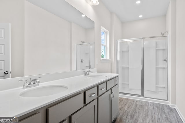 bathroom with an enclosed shower, vanity, and hardwood / wood-style flooring