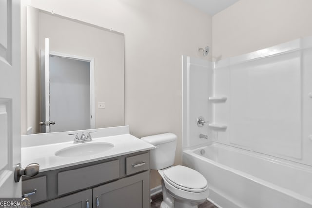 full bathroom featuring toilet, vanity, and bathing tub / shower combination