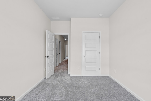 unfurnished bedroom with a closet and carpet