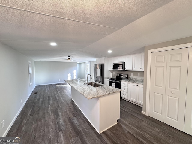 kitchen featuring a center island with sink, white cabinetry, appliances with stainless steel finishes, ceiling fan, and sink