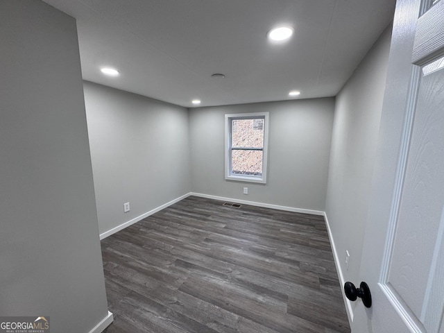 empty room with dark wood-type flooring