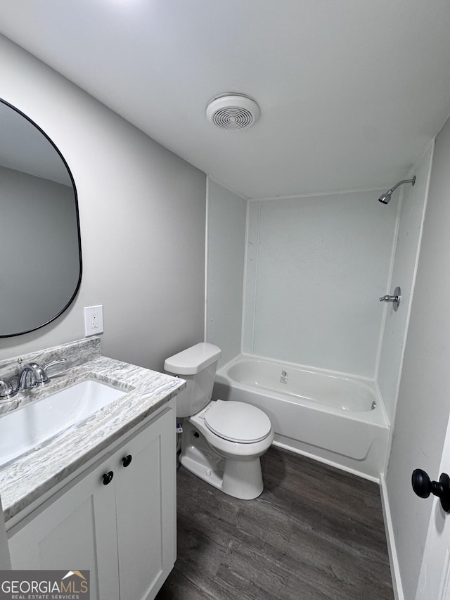 full bathroom featuring toilet, shower / bath combination, hardwood / wood-style floors, and vanity