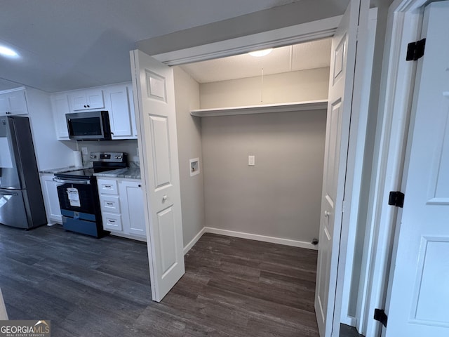 kitchen featuring light stone countertops, white cabinetry, dark hardwood / wood-style floors, and appliances with stainless steel finishes