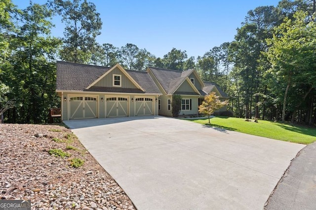 craftsman-style house featuring a front lawn and a garage