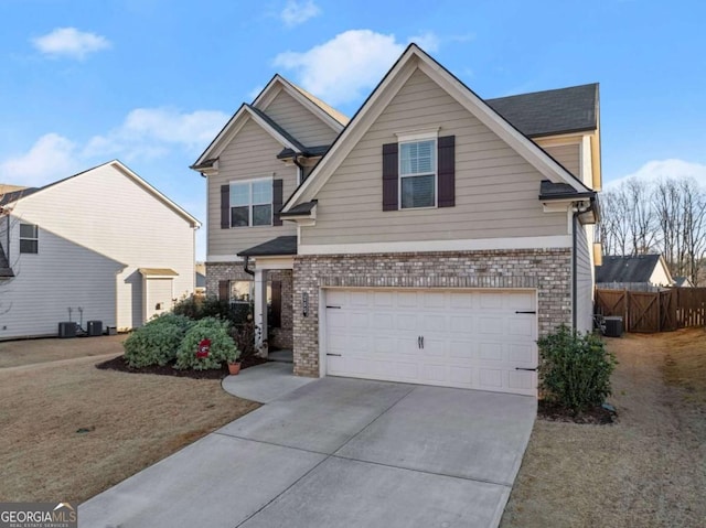 view of front of home featuring a front lawn, central AC unit, and a garage