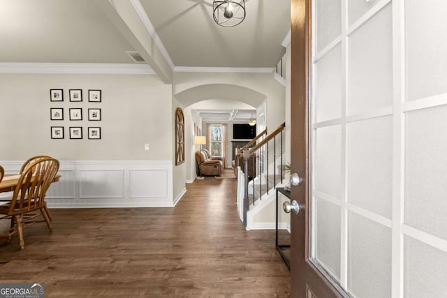 entryway featuring ornamental molding and dark wood-type flooring