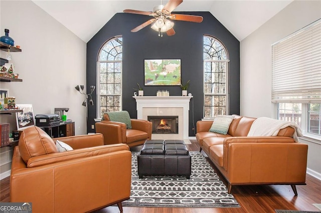 living room featuring lofted ceiling, ceiling fan, and dark hardwood / wood-style flooring