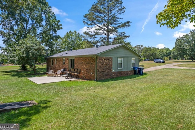 back of house featuring a patio and a yard