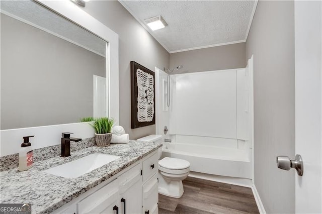 full bathroom with hardwood / wood-style floors, toilet, vanity, a textured ceiling, and  shower combination