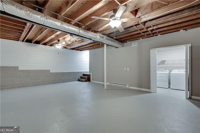 basement featuring a baseboard heating unit and washer and dryer