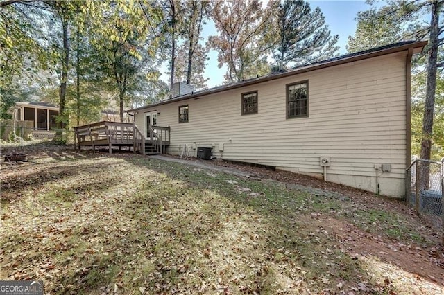 back of property featuring a deck and cooling unit