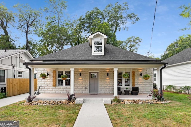 view of front of home featuring a front yard and a porch