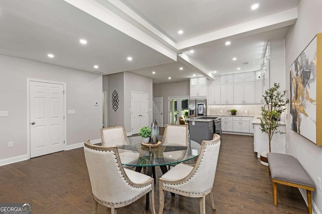 dining room featuring beam ceiling and dark hardwood / wood-style floors