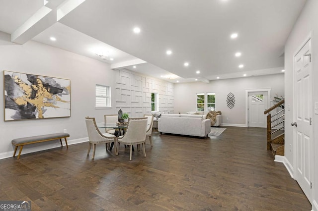 dining room with beam ceiling and dark hardwood / wood-style floors