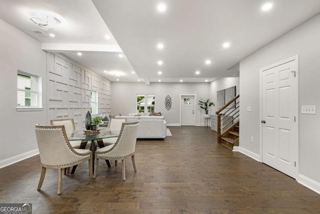 dining area with beamed ceiling and dark hardwood / wood-style floors