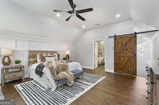 bedroom with ensuite bathroom, ceiling fan, a barn door, and dark hardwood / wood-style floors