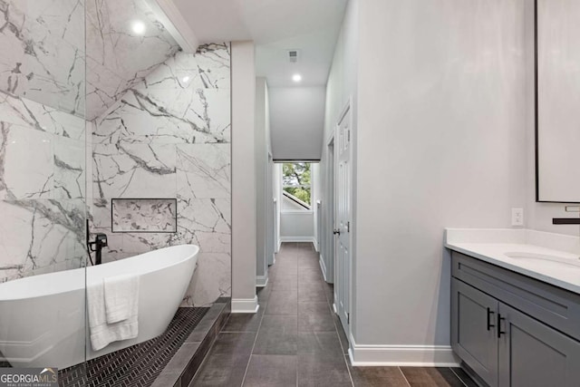 bathroom featuring a tub and vanity