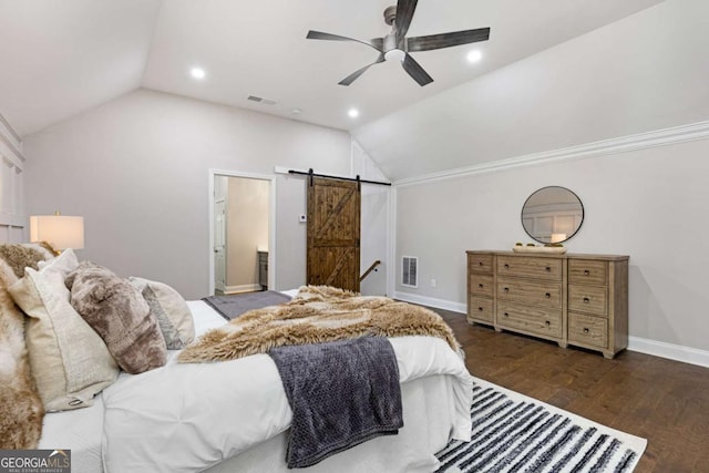 bedroom featuring lofted ceiling, dark hardwood / wood-style flooring, ceiling fan, and a barn door