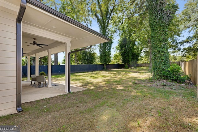 view of yard featuring ceiling fan and a patio area