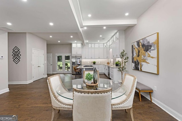 dining space featuring sink and dark hardwood / wood-style floors