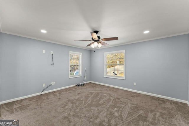 carpeted empty room featuring ceiling fan and crown molding