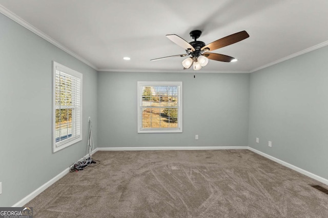 carpeted empty room with ceiling fan and crown molding