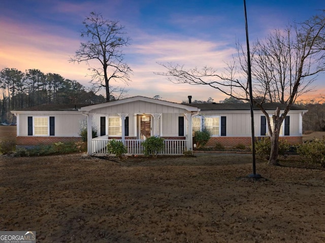 single story home featuring covered porch