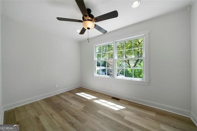 empty room featuring light wood-type flooring and ceiling fan