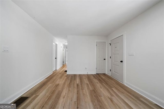 empty room with light hardwood / wood-style floors