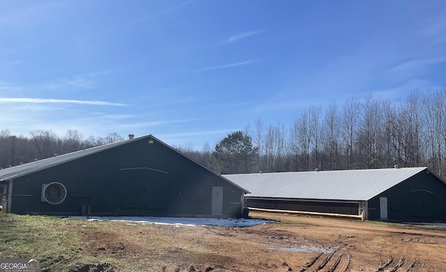 view of side of home featuring an outbuilding