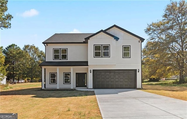 view of front of property with a front yard and a garage