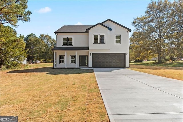 view of front of home with a garage and a front lawn