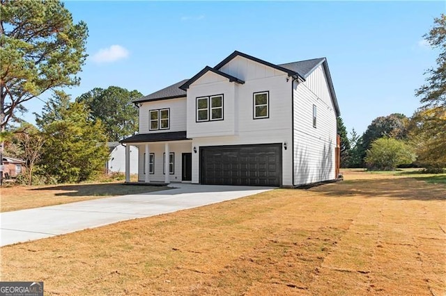 modern farmhouse style home with a front lawn and a garage