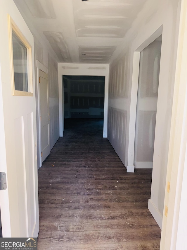 hall with dark wood-style flooring