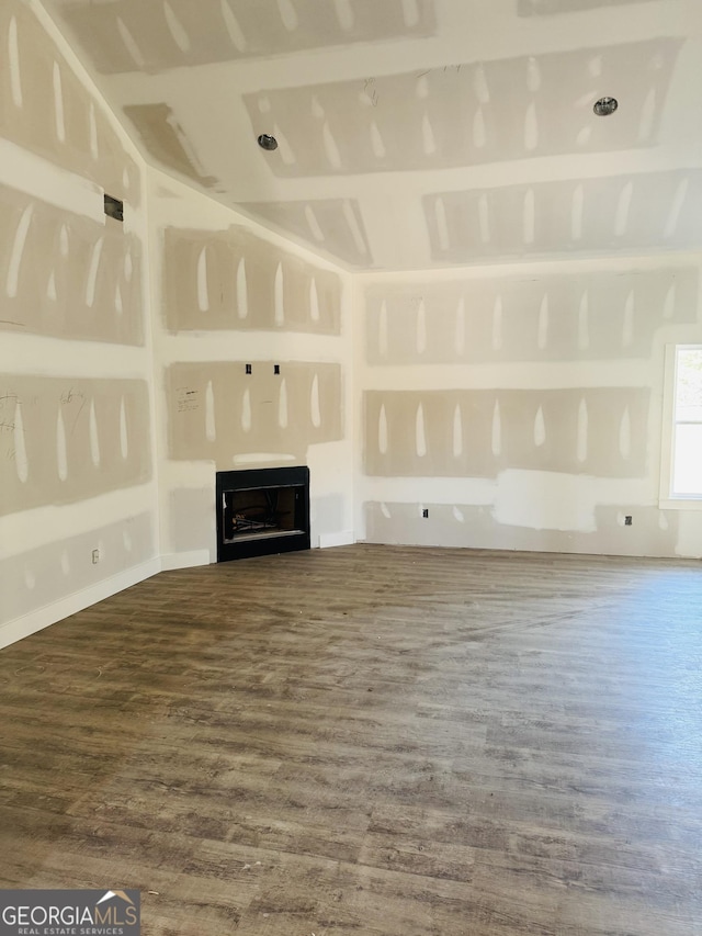 unfurnished living room with a fireplace and wood finished floors