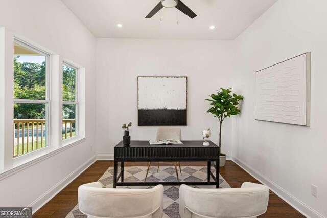 office area with dark wood-type flooring and ceiling fan