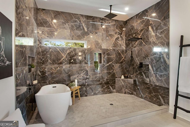 bathroom featuring tile patterned floors, tile walls, and plus walk in shower