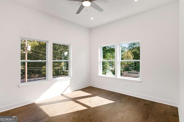 unfurnished room with ceiling fan and dark wood-type flooring