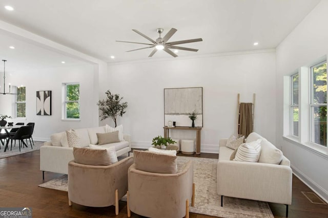 living room with ceiling fan, crown molding, dark hardwood / wood-style floors, and beam ceiling