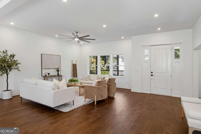 living room featuring ceiling fan and dark wood-type flooring