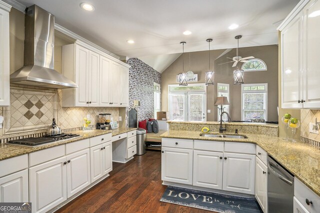 kitchen with white cabinets, stainless steel appliances, sink, and wall chimney exhaust hood