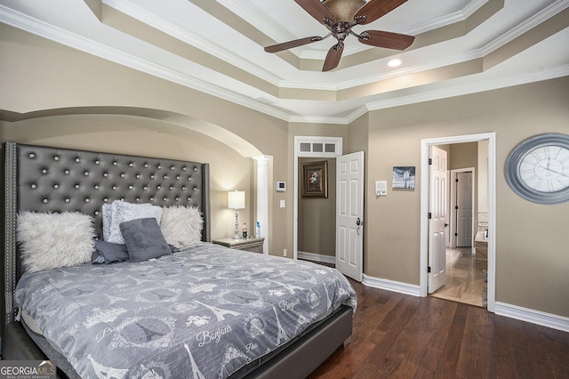 bedroom with ornamental molding, a raised ceiling, and ceiling fan