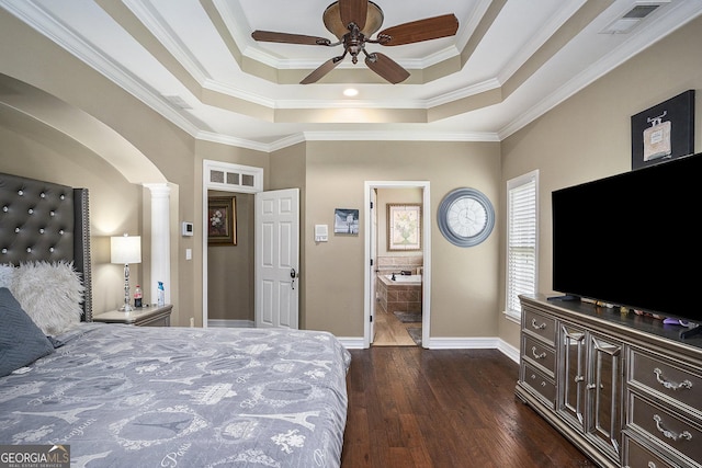 bedroom featuring decorative columns, a raised ceiling, dark wood-type flooring, and ceiling fan